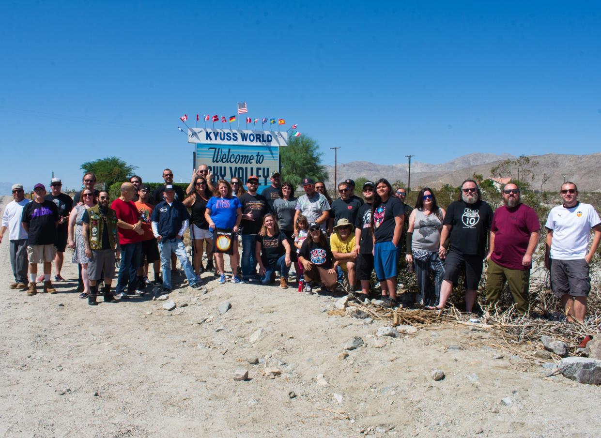 About 50 members of the Facebook group Kyuss World gathered at the "Welcome to Sky Valley" sign in Sky Valley, Calif., on September 17, 2022.