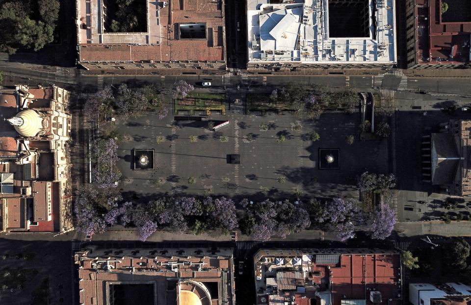 Aerial view of the empty Liberacion square in Guadalajara, Mexico, taken on March 25, 2020 at around eight am. - Central squares and parks in Latin America, which otherwise would be crowded, remained empty Wednesday at around eight am due to the lack of people circulating, as the world faces the new coronavirus pandemic. (Photo by ULISES RUIZ / AFP) (Photo by ULISES RUIZ/AFP via Getty Images)