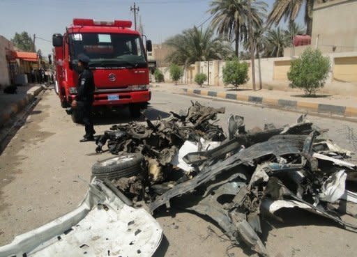 Iraqi rescue teams arrive at the scene of two car bombs that ripped through a group of policemen outside the local ogvernor's home in Diwaniyah. Two suicide car bombs ripped through a guard post killing 26 people outside the provincial governor's home in Diwaniyah city, officials said, as violence surged across Iraq