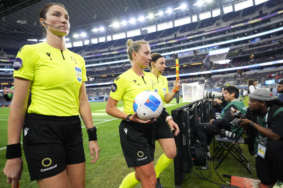 FILE - Referees, from left, Kathryn Nesbitt, Tori Penso and Brooke Mayo walk off the field for half time during a CONCACAF Nations League third place soccer match in Arlington, Texas, March 24, 2024. Women match officials were appointed to work the Copa America for the first time on Friday, May 24, 2024. (AP Photo/Julio Cortez, File)