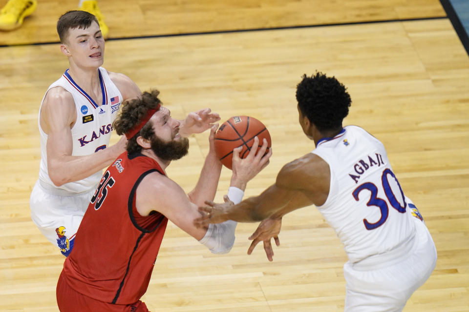 Eastern Washington forward Tanner Groves (35) is pressured by Kansas guard Christian Braun, left, and Kansas guard Ochai Agbaji (30) as he goes up for a shot during the second half of a first-round game in the NCAA college basketball tournament at Farmers Coliseum in Indianapolis, Saturday, March 20, 2021. (AP Photo/AJ Mast)