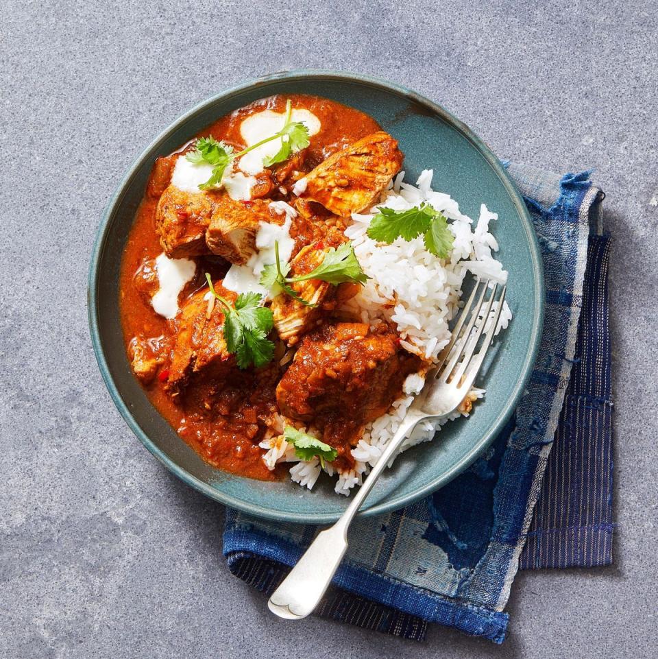 traditional chicken curry with white rice on a plate