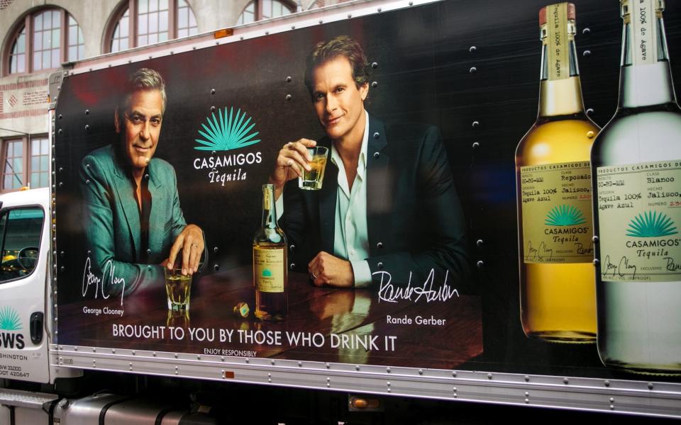 The side of a delivery truck features a billboard promoting George Clooney and Rande Gerber's Casamigos Tequila - George Rose/Getty Images