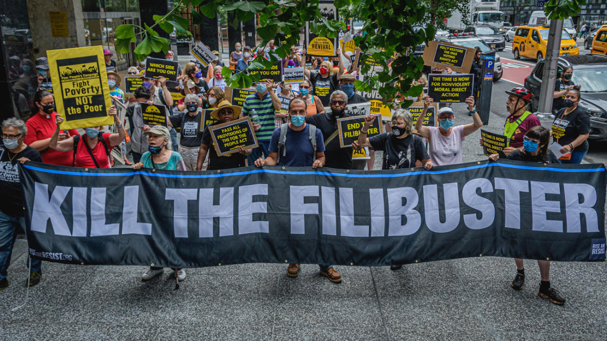 Protesters seen holding a banner