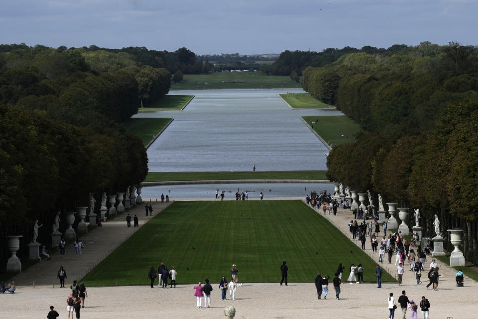 Visitors stroll in the park of the Chateau de Versailles, outside Paris, France, Tuesday, Sept.19, 2023. The park of the Chateau de Versailles will host the equestrian events at the Paris 2024 Olympic Games. (AP Photo/Christophe Ena, File)