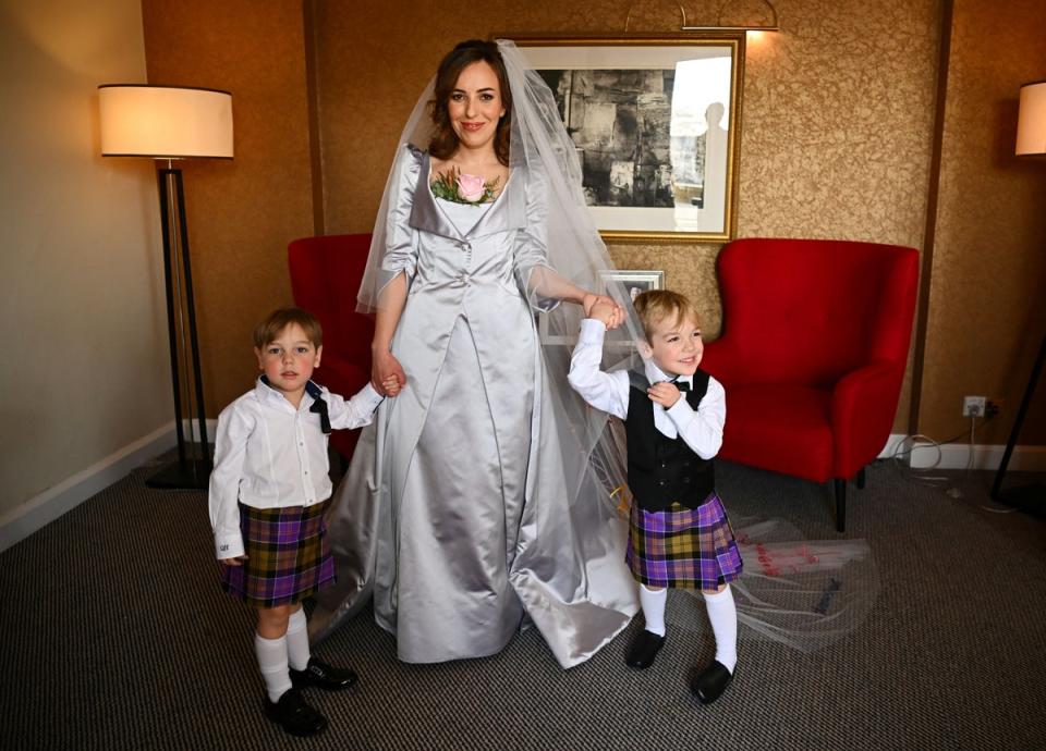 Stella Moris, the partner of Wikileaks founder Julian Assange, is photographed in her Vivienne Westwood designed wedding dress, with their sons Max, three, and Gabriel, four, at a hotel in London (PA)