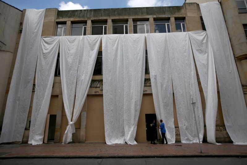 The facade of a bank is covered with plastic, one day before a national strike in Bogota