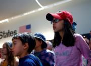 Young visitors watch footage at the exact 50 year anniversary of the Apollo 11 moon landing at the Museum of Flight in Seattle