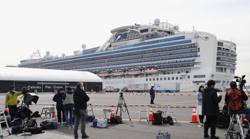 News crews standing near the docked Diamond Princess.
