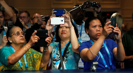 Relatives take photos as students take the stage for a preliminary round of the 89th annual Scripps National Spelling Bee at National Harbor in Maryland, U.S., May 25, 2016. REUTERS/Kevin Lamarque