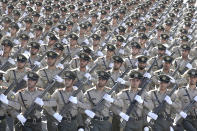 ADDS THAT ATTACK WAS ON A DIFFERENT MILITARY PARADE IN THE SOUTHWESTERN CITY OF AHVAZ - Iranian armed forces members march in a military parade marking the 38th anniversary of Iraq's 1980 invasion of Iran, in front of the shrine of the late revolutionary founder, Ayatollah Khomeini, outside Tehran, Iran, Saturday, Sept. 22, 2018. Elsewhere gunmen disguised as soldiers attacked the annual parade in the southwestern city of Ahvaz, killing dozens of people and wounding others in the bloodiest assault to strike the country in recent years. (AP Photo/Ebrahim Noroozi)