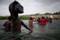 Migrants seeking refuge in the U.S. cross Rio Grande river, in Ciudad Acuna