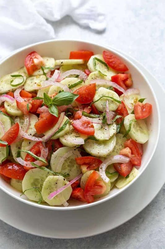 <p>The Blond Cook</p><p>This cucumber tomato salad seasoned with dill and fresh basil in a homemade vinaigrette is an easy, healthy and flavorful side salad!</p><p><strong>Get the recipe: <a href="https://theblondcook.com/cucumber-tomato-salad/" rel="nofollow noopener" target="_blank" data-ylk="slk:Cucumber Tomato Salad;elm:context_link;itc:0;sec:content-canvas" class="link ">Cucumber Tomato Salad</a></strong></p>