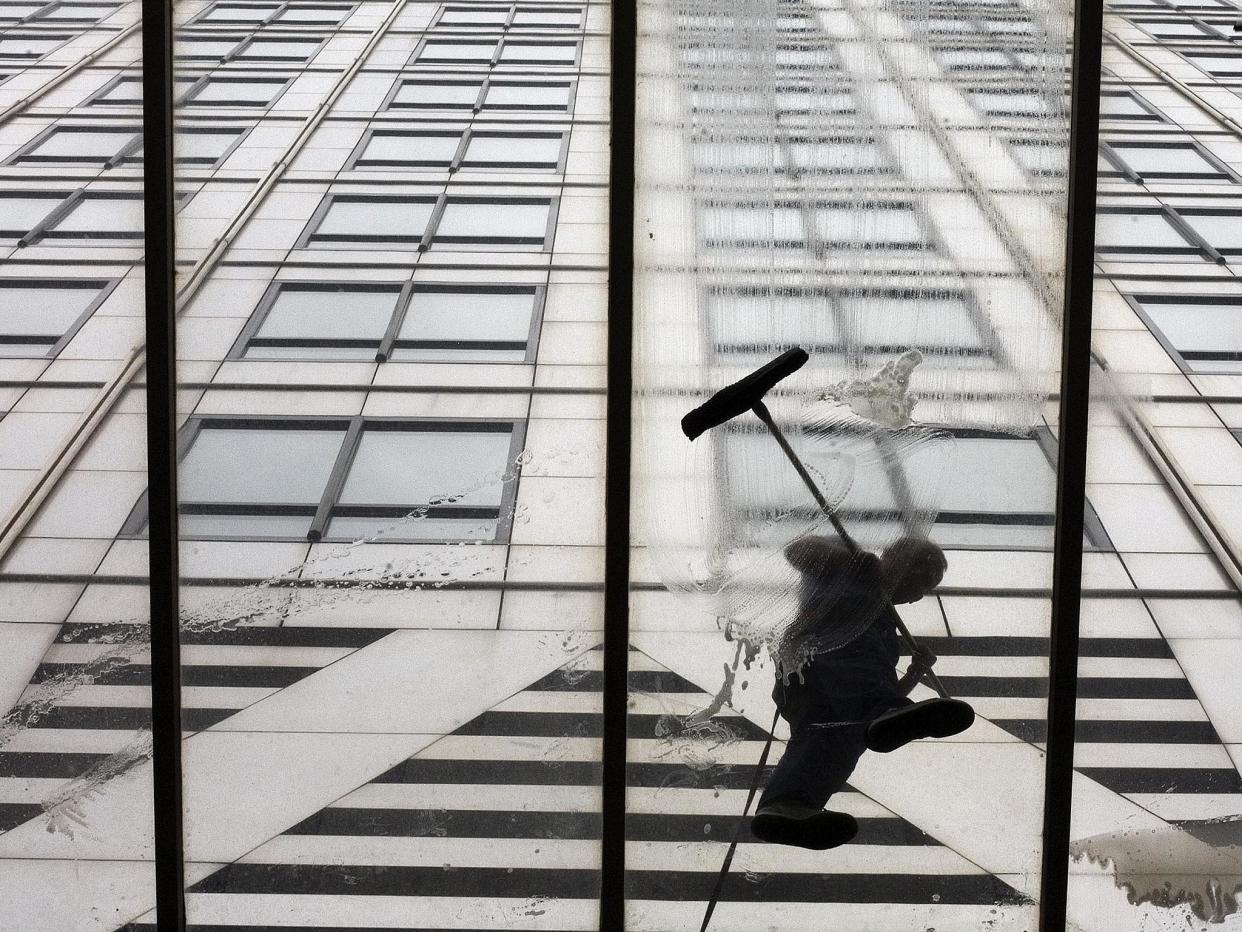 Workmen wash the entrance of 1 Canada Square in London's Canary Wharf, where the European Banking Authority is based - for now: Reuters