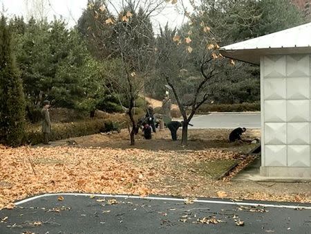 North Korean soldiers dig a trench and plant trees in the area where, on November 13, a defector ran across the border at the Demilitarized Zone (DMZ) dividing North Korea and South Korea November 22, 2017. Handout via REUTERS