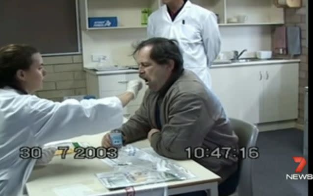 Dieter Pfennig has his mouth swabbed for a DNA sample. Source: 7 News.