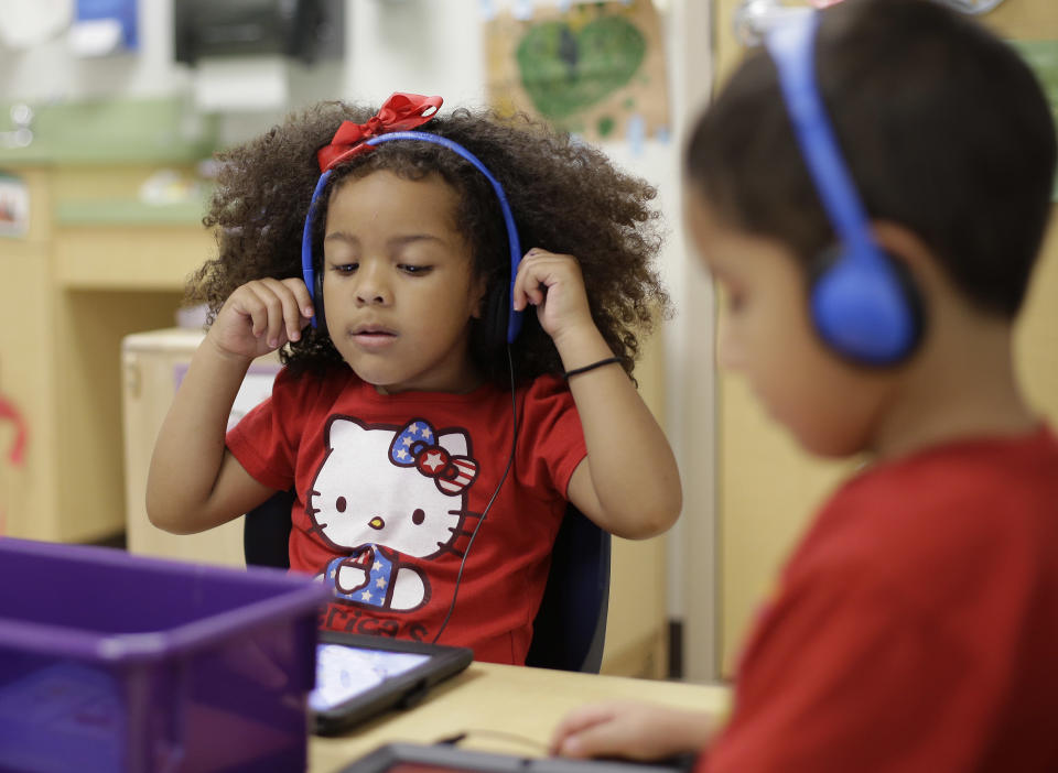 Pre-K students use electronic tablets at the South Education Center, Wednesday, April 2, 2014, in San Antonio. (AP Photo/Eric Gay)