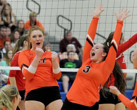 Lauran Hicks (right) celebrates with a teammate on her Dalton High School volleyball team. Her coach, Allison Hostetler, said Hicks always strives to do her best.