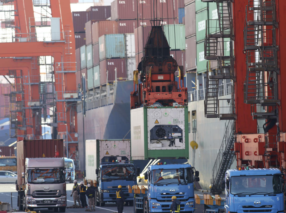 A cargo is unloaded from a truck to load onto a freighter at a port in Tokyo, Monday, Jan 27, 2014. Japan's trade deficit surged to a record 11.47 trillion yen ($112 billion) in 2013 as the shutdown of nuclear power plants swelled the nation's energy import bill. Provisional data Monday showed that exports rose 9.5 percent to 69.8 trillion yen ($680.9 billion), while imports jumped 15 percent to 81.3 trillion yen ($793.2 billion). (AP Photo/Koji Sasahara)