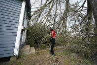 Layla Winbush looks at a fallen tree in front of her damaged home in Lake Charles, La., in the aftermath of Hurricane Laura, Sunday, Aug. 30, 2020. (AP Photo/Gerald Herbert)