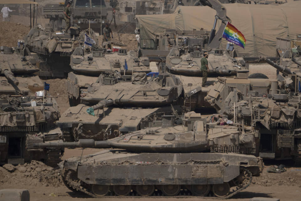 Israeli soldiers stand on top of tanks in a staging area near the Israeli-Gaza border in southern Israel, Monday, June 3, 2024. (AP Photo/Leo Correa)