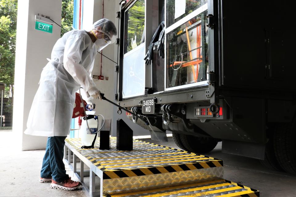 The MSS, which is a modified military ambulance fitted with a protective swab screen, being thoroughly disinfected. (PHOTO: Mindef)