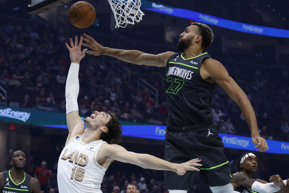 Cleveland Cavaliers forward Cedi Osman (16) shoots against Minnesota Timberwolves center Rudy Gobert (27) during the first half of an NBA basketball game, Sunday, Nov. 13, 2022, in Cleveland. (AP Photo/Ron Schwane)