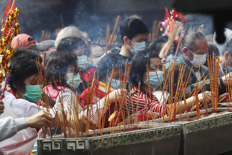 People burn joss sticks as they pray at the Wong Tai Sin Temple, in Hong Kong, Saturday, Jan. 25, 2020 to celebrate the Lunar New Year which marks the Year of the Rat in the Chinese zodiac. (AP Photo/Achmad Ibrahim)