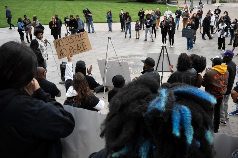 Sep 30, 2022; Columbus, OH, United States; Ramon Obey II, left, addresses the crowd during a community press conference Friday outside of the Ohio Statehouse. Speakers included vice president with the NAACP Ohio chapter Dr. Derrick L. Foward, president of NAACP Ohio chapter Tom Roberts, and Dejaun Sharb, a community member from Lewis’ neighborhood. Mandatory Credit: Joseph Scheller-The Columbus Dispatch