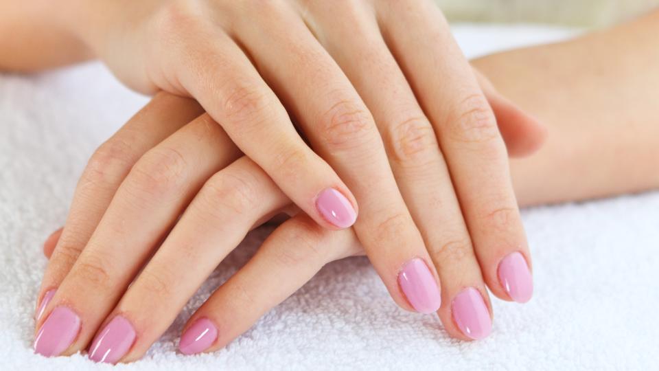 Hand with a light pink manicure