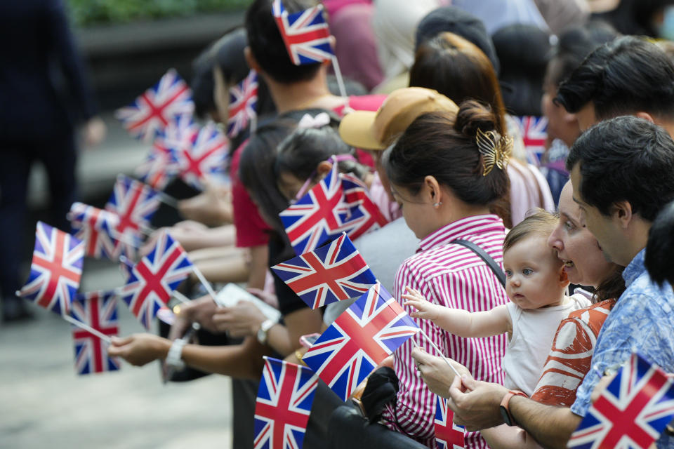 Ervan Costa, second right, and baby Albany Costa wait for arrival of Britain's Prince William at Jewel in Changi airport, Singapore, Sunday, Nov. 5, 2023. (AP Photo/Vincent Thian)