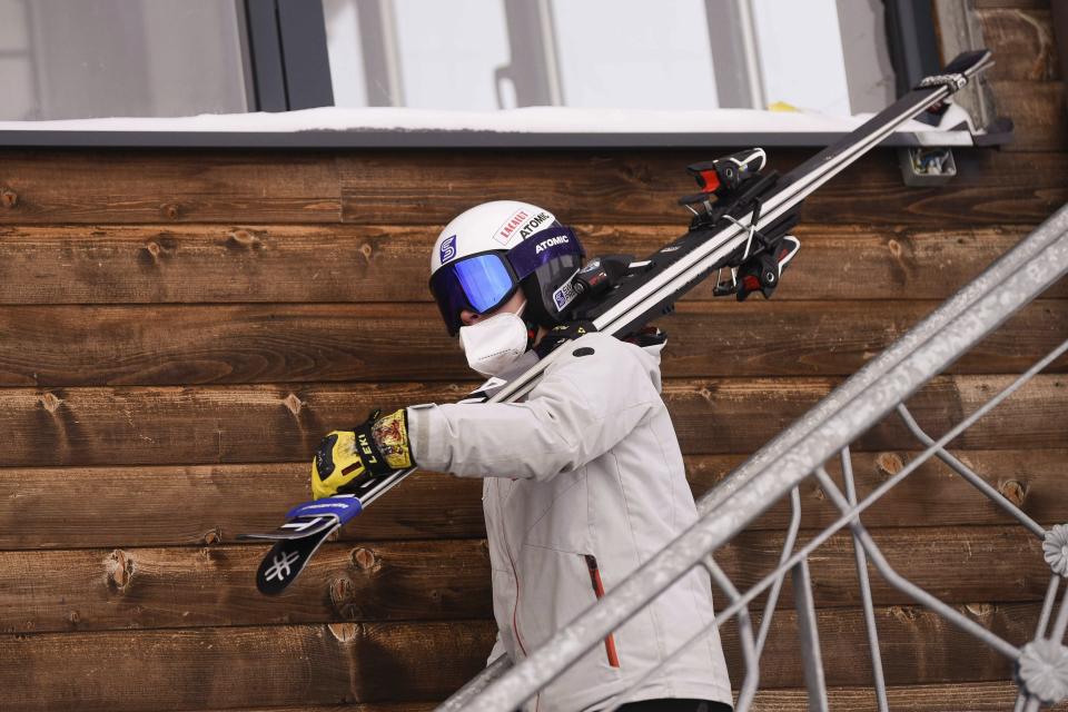Kiana Kryeziu carries her skis prior to training at the Arxhena Ski center in Dragas, Kosovo on Saturday, Jan. 22, 2022. The 17-year-old Kryeziu is the first female athlete from Kosovo at the Olympic Winter Games after she met the required standards, with the last races held in Italy. (AP Photo/Visar Kryeziu)