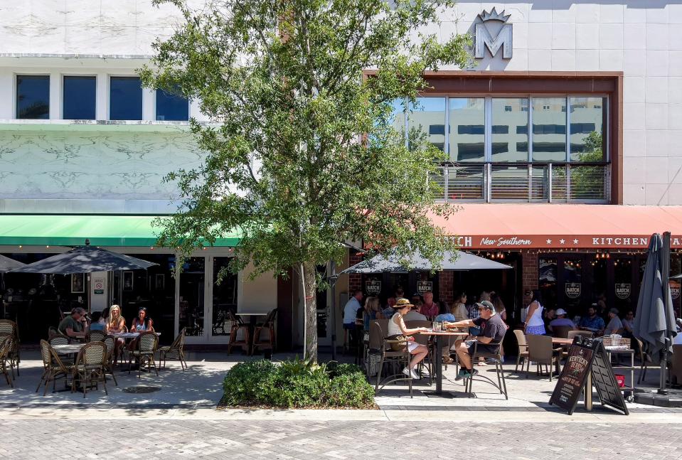 Patrons enjoy Sunday brunch along Clematis Street in West Palm Beach, Florida on April 24, 2022.