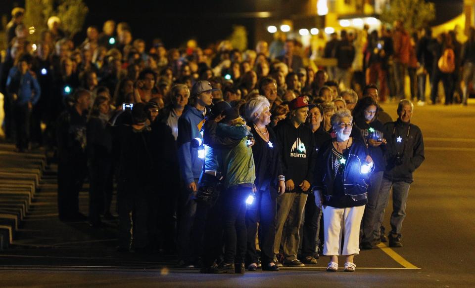 People walk during the "Marche Silencieuse de la Lumiere et de la Vie" in Lac-Megantic