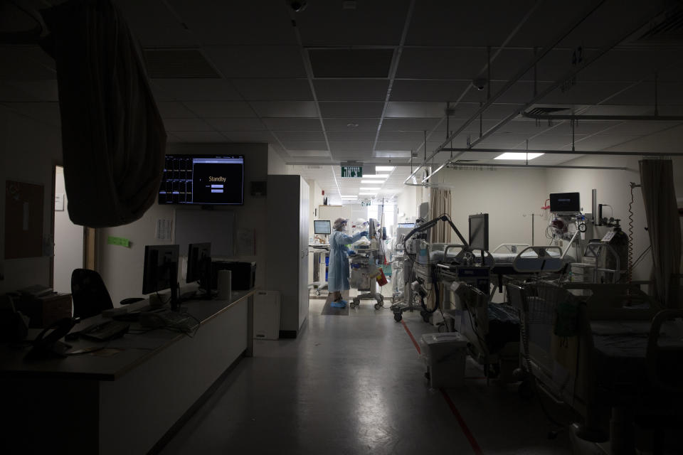 FILE - In this Aug. 31, 2021, file, photo, a darkened corridor of empty beds is prepared for patients on the coronavirus ward at Shaare Zedek Medical Center in Jerusalem. Israeli health officials say the booster shot, which has already been delivered to about a third of the population, is helping to suppress the country’s latest wave of COVID-19 infections. (AP Photo/Maya Alleruzzo, File)