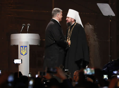 Ukraine's President Petro Poroshenko congratulates newly elected head of the independent Ukrainian Orthodox church Metropolitan Epifaniy (Dumenko) at the Saint Sophia's Cathedral in Kiev, Ukraine December 15, 2018. REUTERS/Gleb Garanich