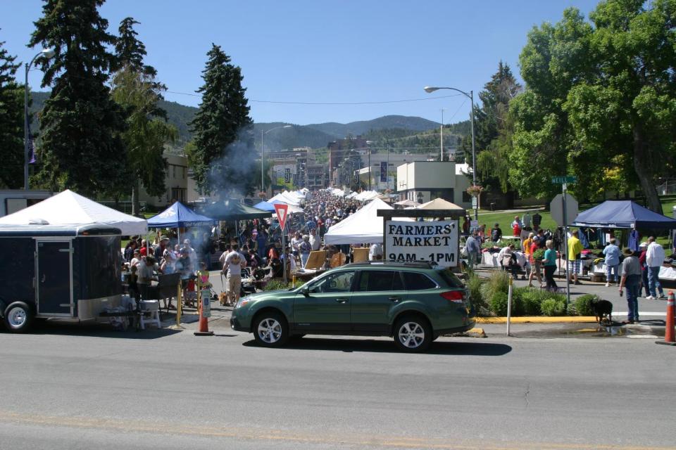 This June 15, 2013 photo shows the farmer’s market in Helena, Mont., a Saturday morning institution. Buskers on violin and guitar provide the soundtrack as kids and dogs romp while neighbors stop to chat. You’ll have to open your wallet to sample fare like cherries and kettle corn, but strolling around and people-watching is fun and free. (AP Photo/Montana Marketing Inc., Scott Peterson)