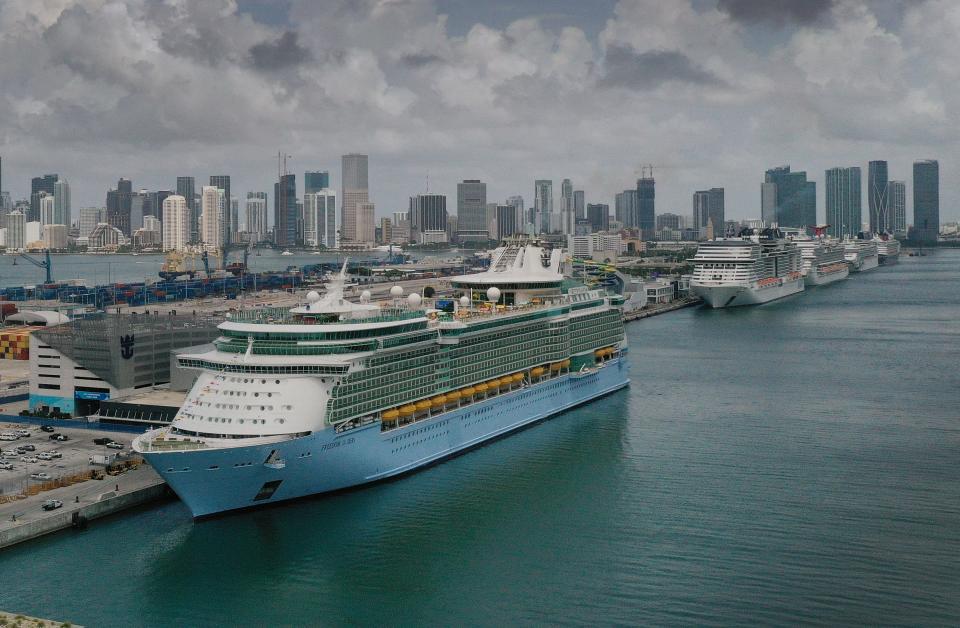 In an aerial view, the Royal Caribbean Freedom of the Seas (L) prepares to set sail from PortMiami during the first U.S. trial cruise testing COVID-19 protocols on June 20, 2021 in Miami, Florida.