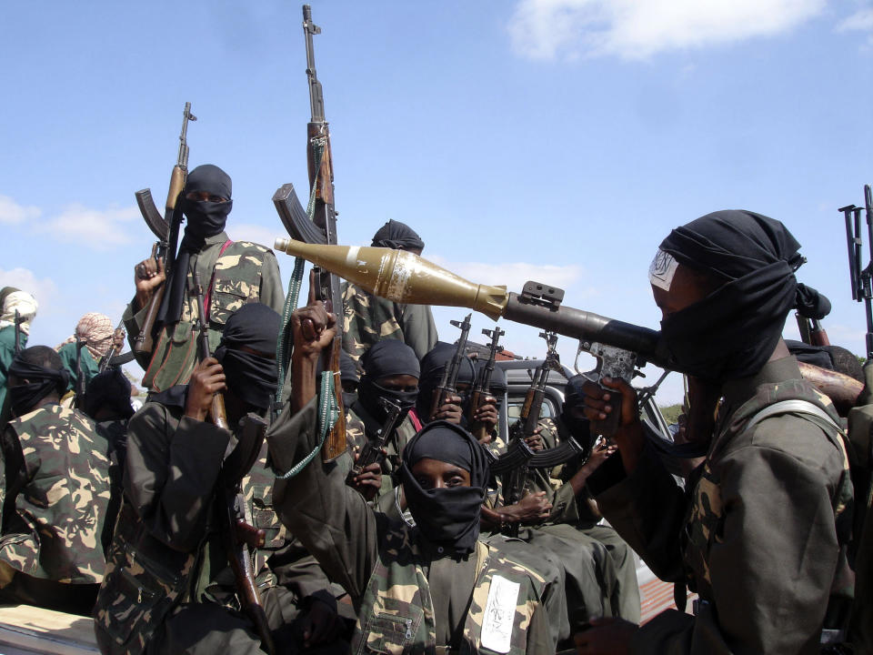 FILE - Armed al-Shabab fighters ride on pickup trucks as they prepare to travel into the city, just outside the capital Mogadishu, Somalia, Dec. 8, 2008. The al-Shabab extremist group has exploited Ethiopia's internal turmoil to cross the border from neighboring Somalia in unprecedented attacks in July 2022 that a top U.S. military commander has warned could continue. (AP Photo/Farah Abdi Warsameh, File)