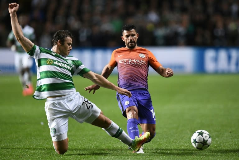 Celtic's Danish defender Erik Sviatchenko (L) tackles Manchester City's Argentinian striker Sergio Aguero during the UEFA Champions League Group C football match between Celtic and Manchester City