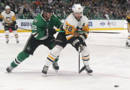 Pittsburgh Penguins defenseman Kris Letang (58) skates for the puck against Dallas Stars center Radek Faksa (12) during the first period of an NHL hockey game in Dallas, Saturday, Jan. 8, 2022. (AP Photo/LM Otero)