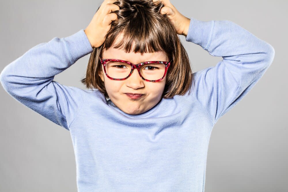 angry girl scratching her head