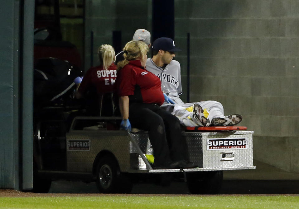 Former New York Yankees' outfielder Dustin Fowler is taken off the field after he was injured his MLB debut at Guaranteed Rate Field in Chicago. (AP)