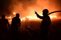 Fire burns a house in Adames area, in northern Athens, Greece, Tuesday, Aug. 3, 2021.Thousands of people fled their homes north of Athens on Tuesday as a wildfire broke out of the forest and reached residential areas. The hurried evacuations took place just as Greece grappled with its worst heat wave in decades. (AP Photo/Michael Varaklas)