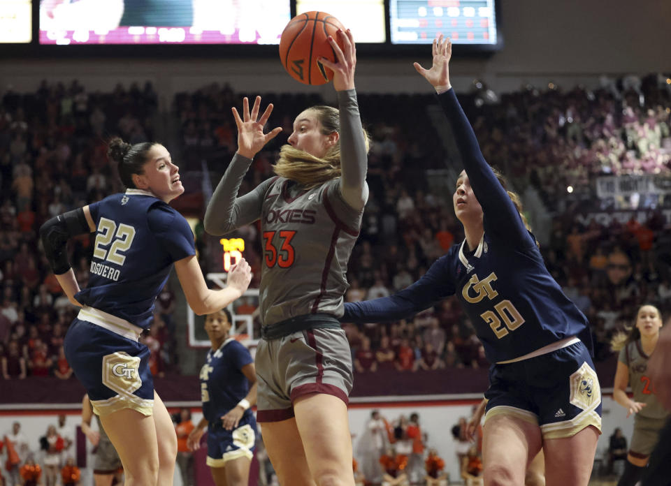 Virginia Tech's Elizabeth Kitley (33) is defended by Georgia Tech's Inés Noguero (22) and Ariadna Termis (20) in the second half of an NCAA college basketball game Thursday, Jan. 25, 2024, in Blacksburg, Va. (Matt Gentry/The Roanoke Times via AP)