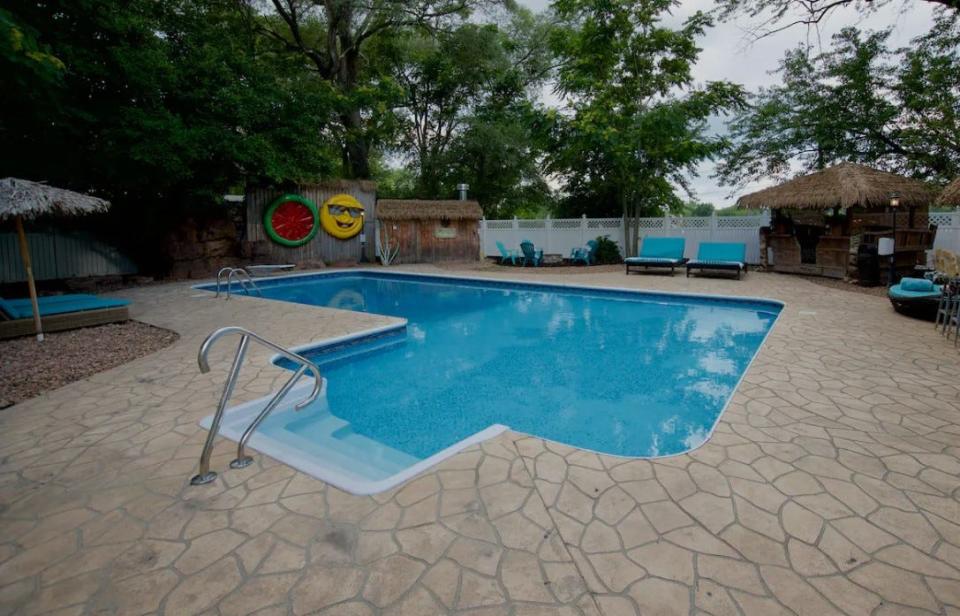 This home in south Des Moines features a pool, a hot tub, tiki bar, and more.