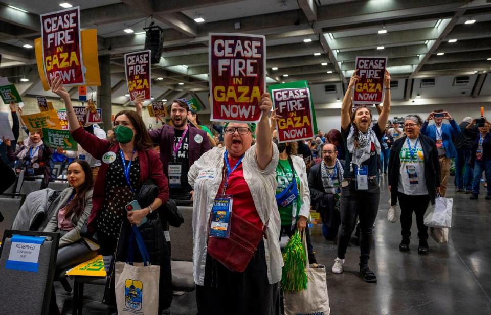 Supporters of U.S. Senate candidate Barbara Lee hold signs calling for a cease-fire in the Israel-Hamas war as she speaks at the Democratic nominating convention at SAFE Credit Union Convention Center.