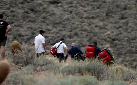 Emergency personnel arrive at the scene of the deadly tour helicopter crash along the jagged rocks of the Grand Canyon - Credit: AP