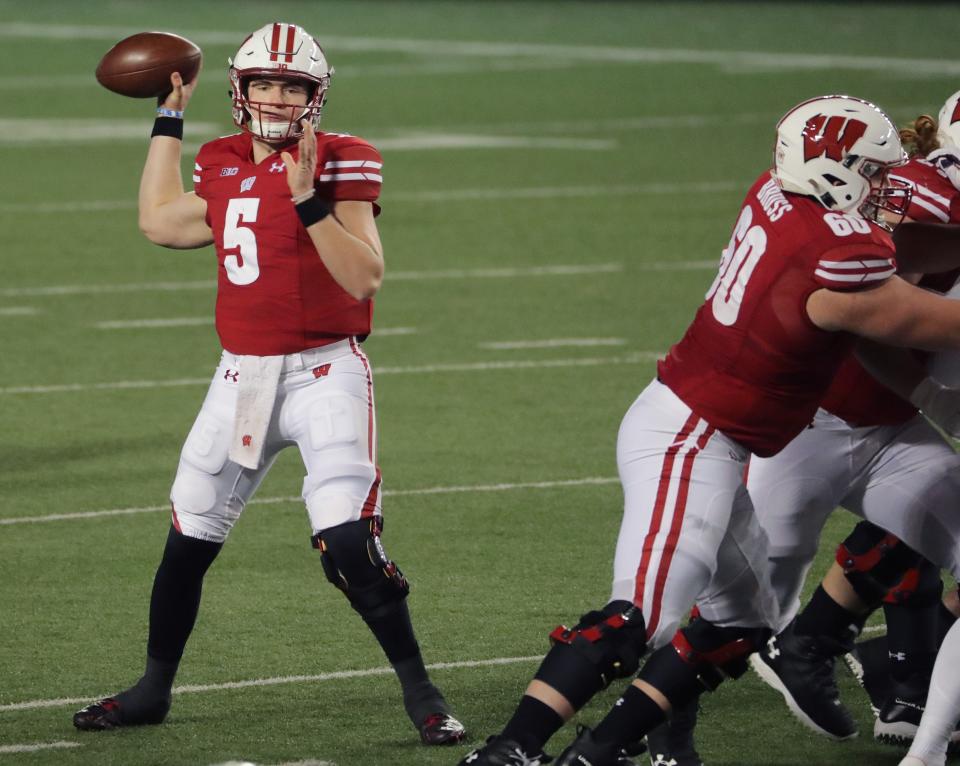 Wisconsin quarterback Graham Mertz looks and completes one of his 20 completed passes in the season opener against Illinois in 2020, his first game as the starter. Mertz only threw one incompletion and threw four of his five touchdowns in the first half in Wisconsin's victory over Illinois.