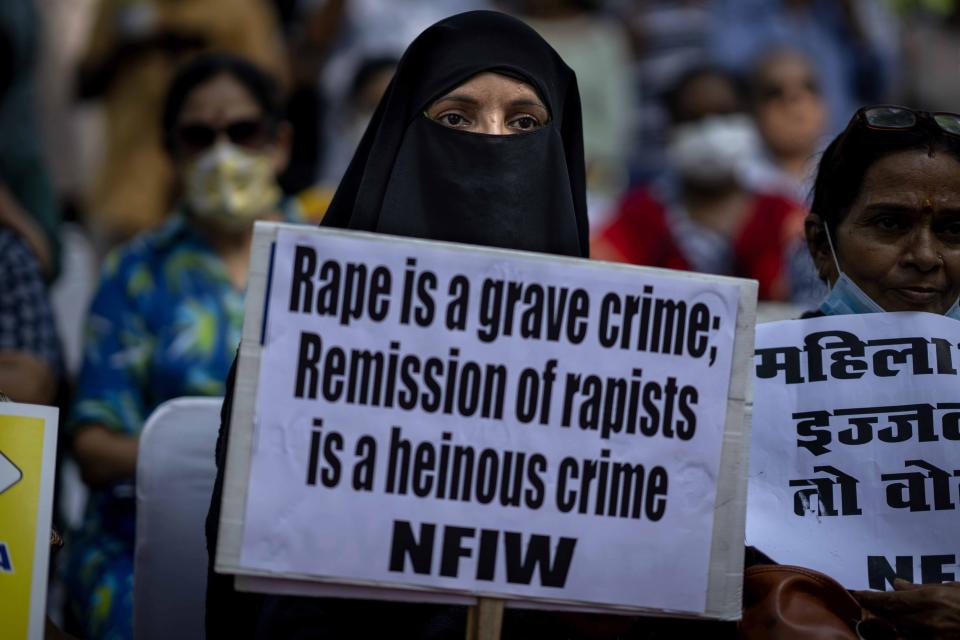 A Muslim woman holds a placard during a protest against remission of sentence by the government to convicts of a gang rape of a Muslim woman, in New Delhi, India, Saturday, Aug. 27, 2022. The victim, who is now in her 40s, was pregnant when she was brutally gang raped in communal violence in 2002 in the western state of Gujarat, which saw over 1,000 people, mostly Muslims, killed in some of the worst religious riots India has experienced since its independence from Britain in 1947. (AP Photo/Altaf Qadri)